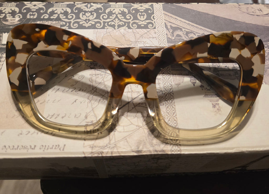 Tortoiseshell glasses on a textured surface