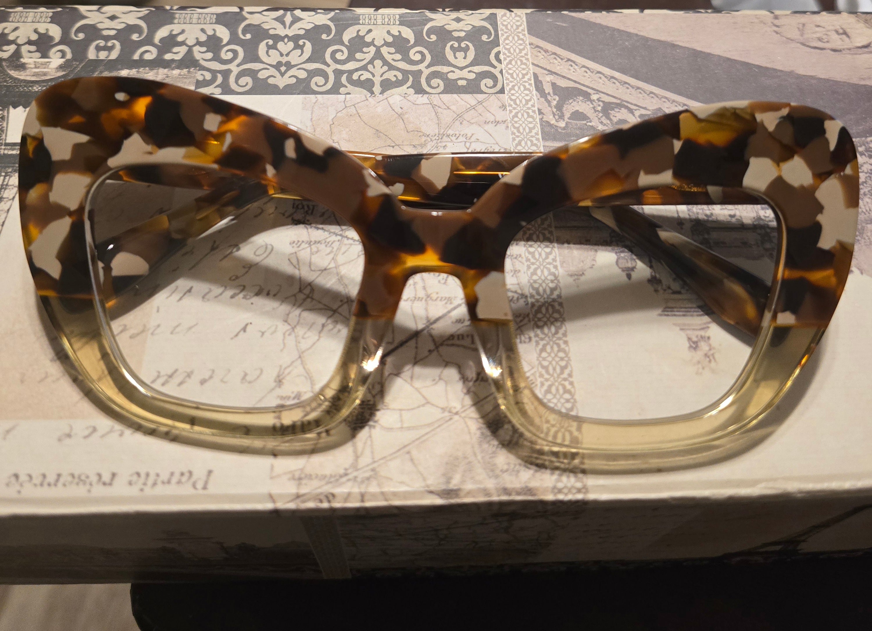 Tortoiseshell glasses on a textured surface
